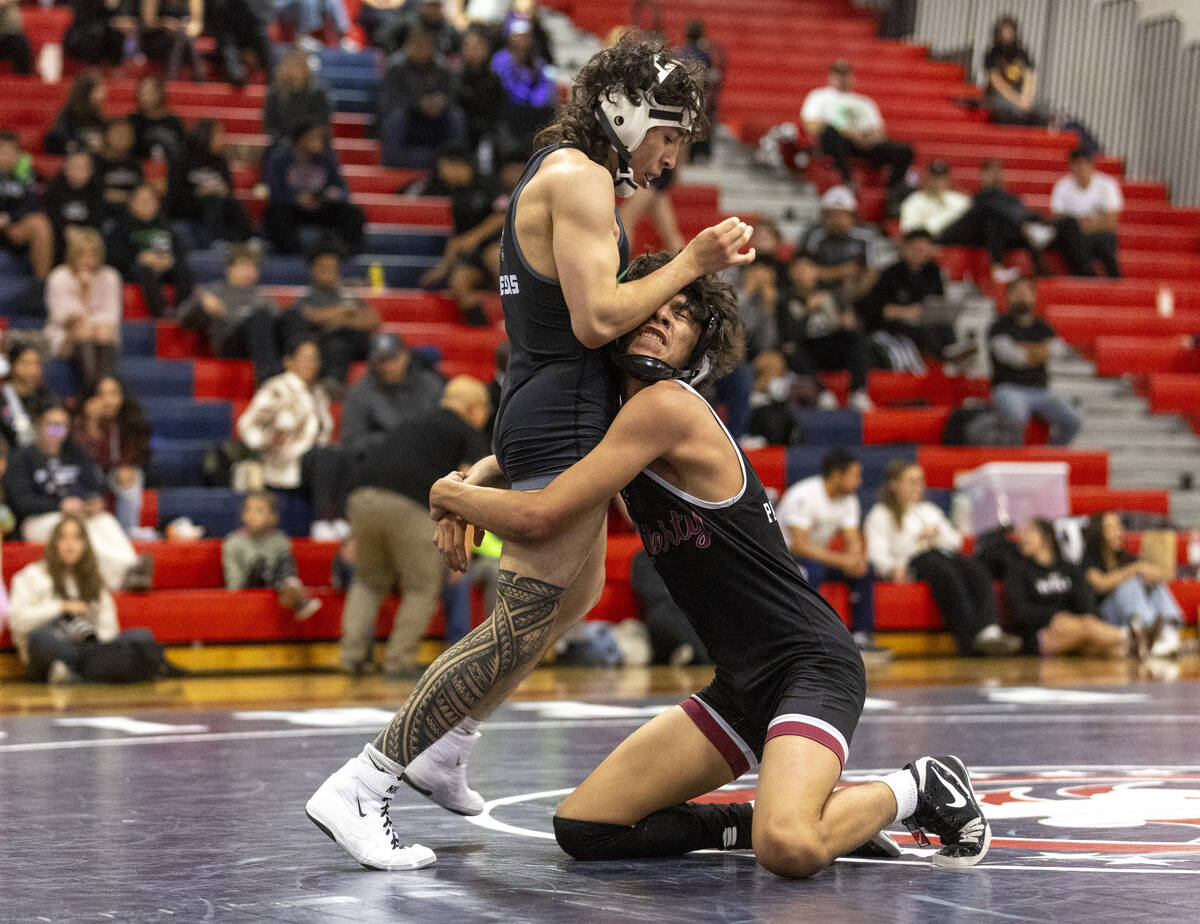 SLAM Academy’s Destin Maestas, left, and Liberty’s Diego Acosta, right, compete during the ...