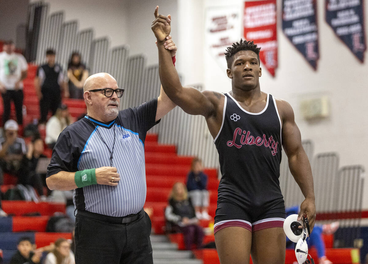 Liberty’s Melvin Whitehead has his hand raised after defeating SLAM Academy’s Sat ...