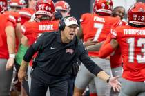 UNLV head coach Barry Odom welcomes players back to the sideline after scoring a touchdown duri ...