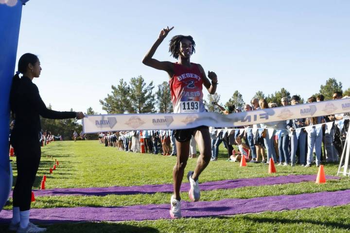 Kenan Dagge of Desert Oasis crosses the finish line during the 5A Southern Region boys cross co ...