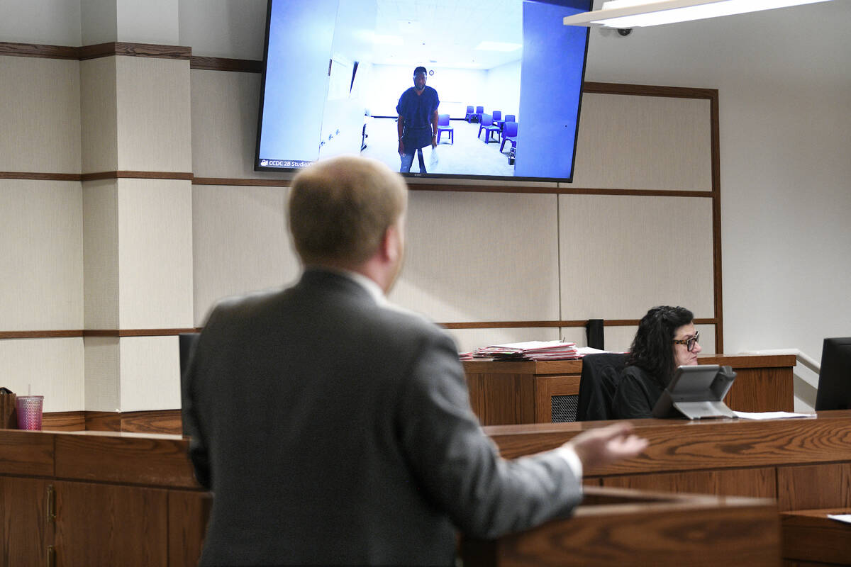 Antwone Washington appears on a monitor while public defender Tyler Gaston argues for his relea ...