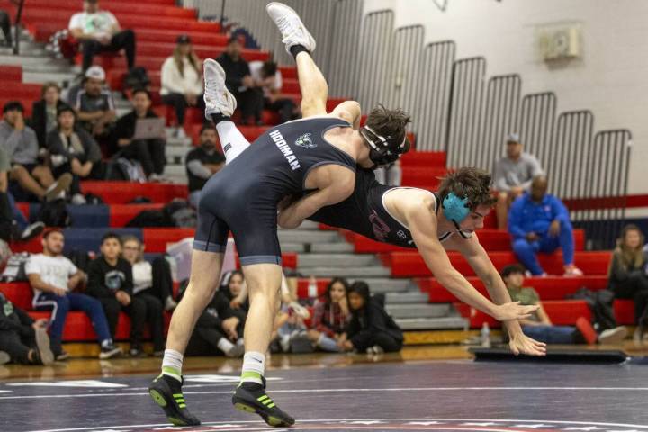 SLAM Academy’s Drake Hooiman, left, tosses Liberty’s Wyatte Nicholson, right, during the hi ...