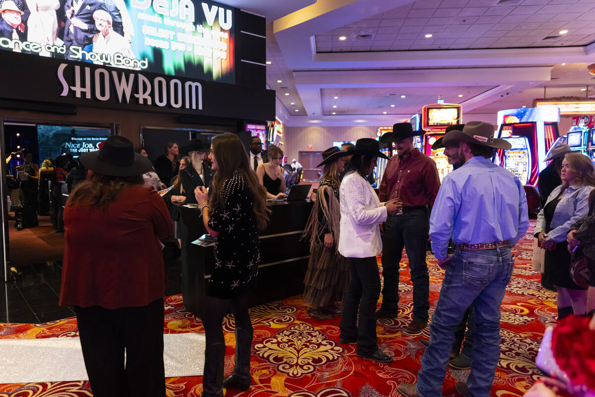 Judy Wagner, center right, talks with friends before the premier of documentary "Nice Job, ...