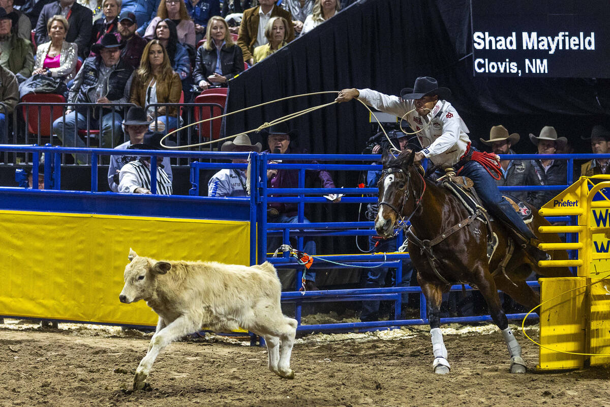 Shad Mayfield eyes his calf in Tie-Down Roping during day 6 action of the NFR at the Thomas & M ...