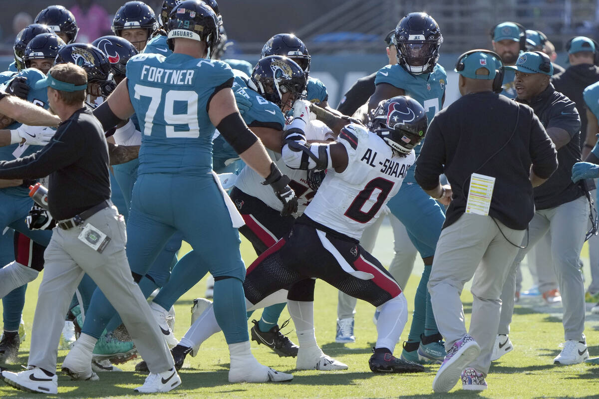 Players fight after Houston Texans linebacker Azeez Al-Shaair (0) hit Jacksonville Jaguars quar ...