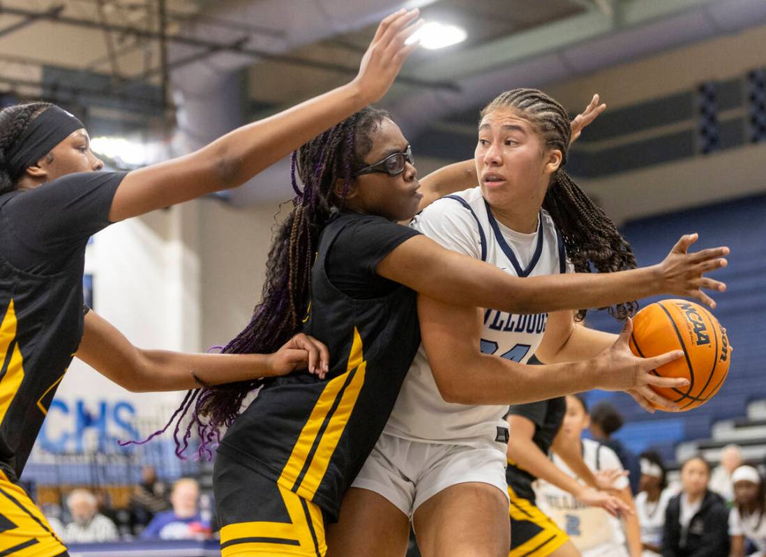 Centennial sophomore Nation Williams, right, looks to pass the ball during the high school girl ...