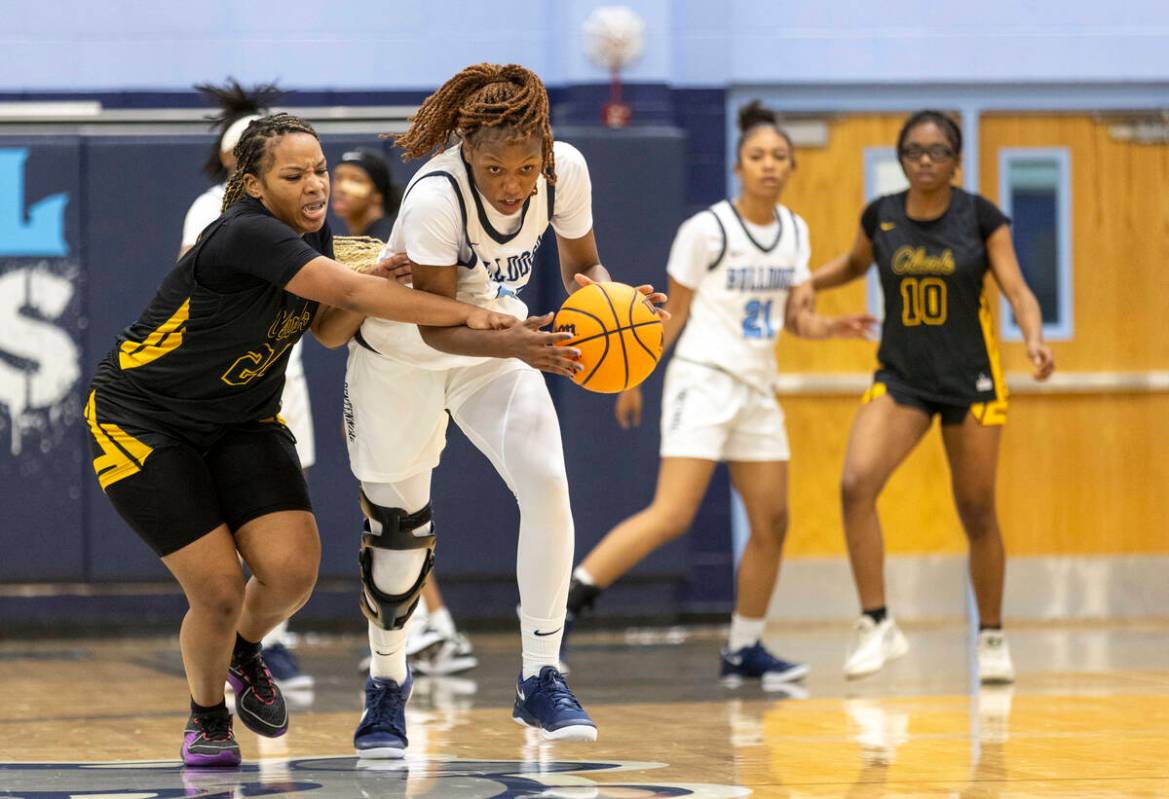 Centennial junior Inieye Oruh, right, steals the ball from Clark’s Paradise Norsworthy, left, ...