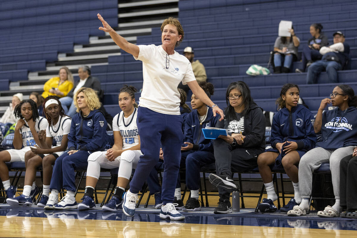 Centennial Head Coach Karen Weitz tells her team what to do during the high school girls basket ...