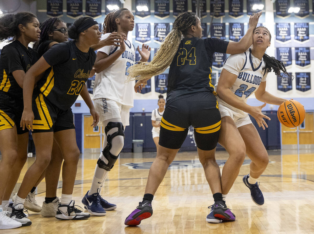 Centennial sophomore Nation Williams (24) is fouled by Clark’s Paradise Norsworthy (24) ...