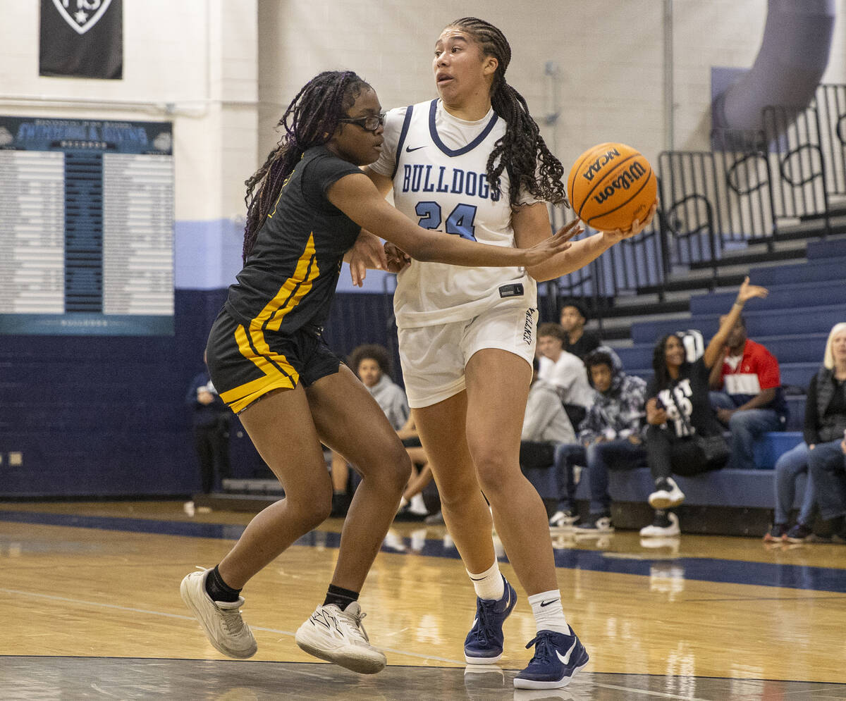 Centennial sophomore Nation Williams (24) looks to pass the ball around Clark’s Marriana ...