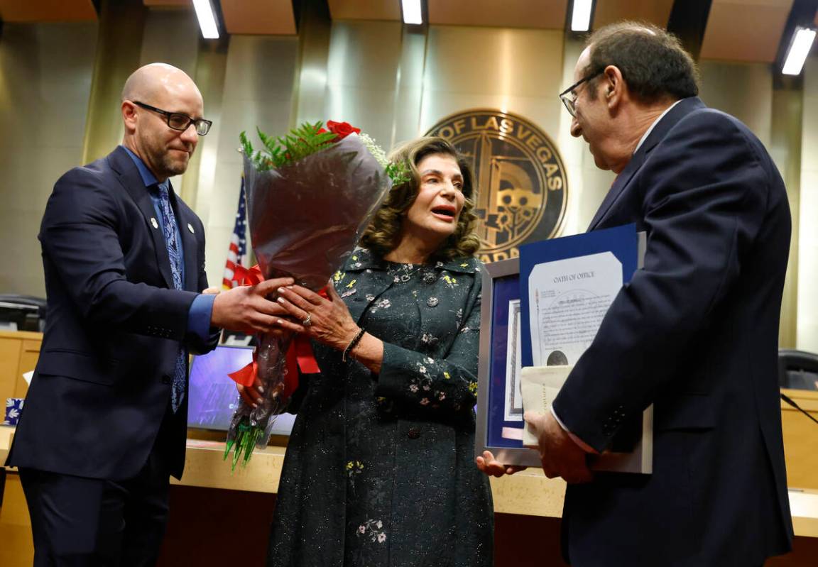 Mayor Shelley Berkley receives flowers from Councilman Brian Knudsen, left, after being sworn i ...