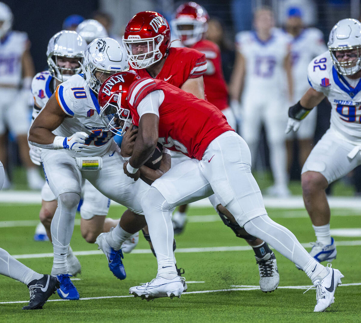 UNLV quarterback Hajj-Malik Williams (6) battles for more yards on a run against Boise State Br ...