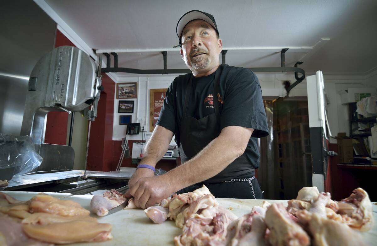 Chuck Frommer chats with a customer in the butcher shop at John Mull's Meats and Road Kill Gril ...