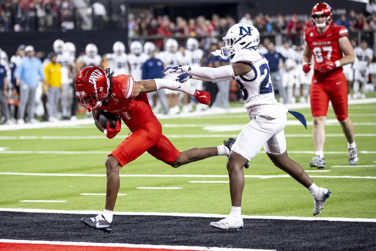 UNLV wide receiver Ricky White III, left, runs into the end zone for a touchdown during the NCA ...