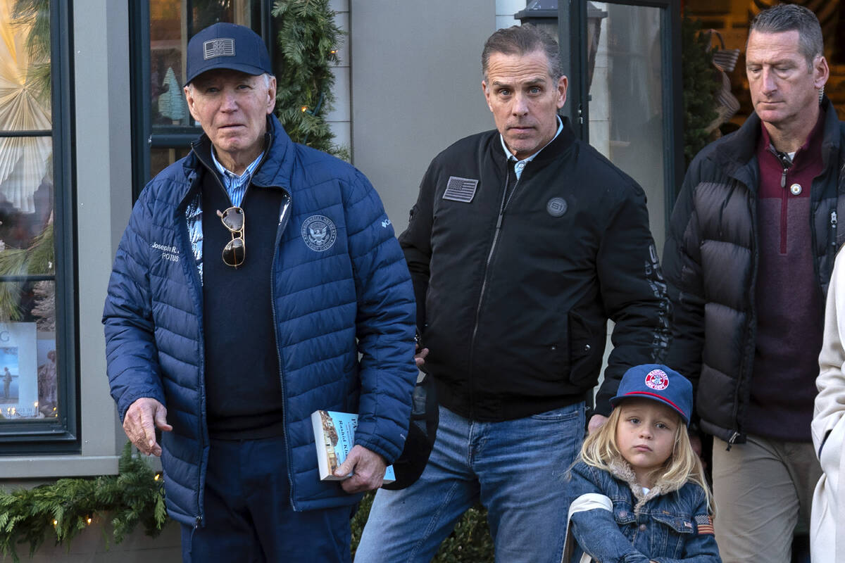 President Joe Biden accompanied by his son Hunter Biden and his grandson Beau leave a book stor ...