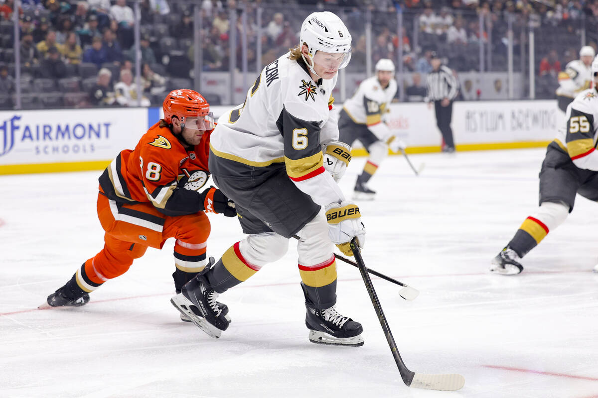 Vegas Golden Knights defenseman Kaedan Korczak, right, controls the puck next to Anaheim Ducks ...