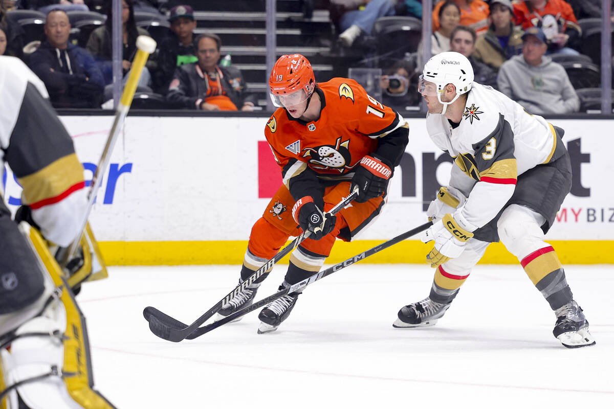 Anaheim Ducks right wing Troy Terry, left, shoots against Vegas Golden Knights defenseman Brayd ...