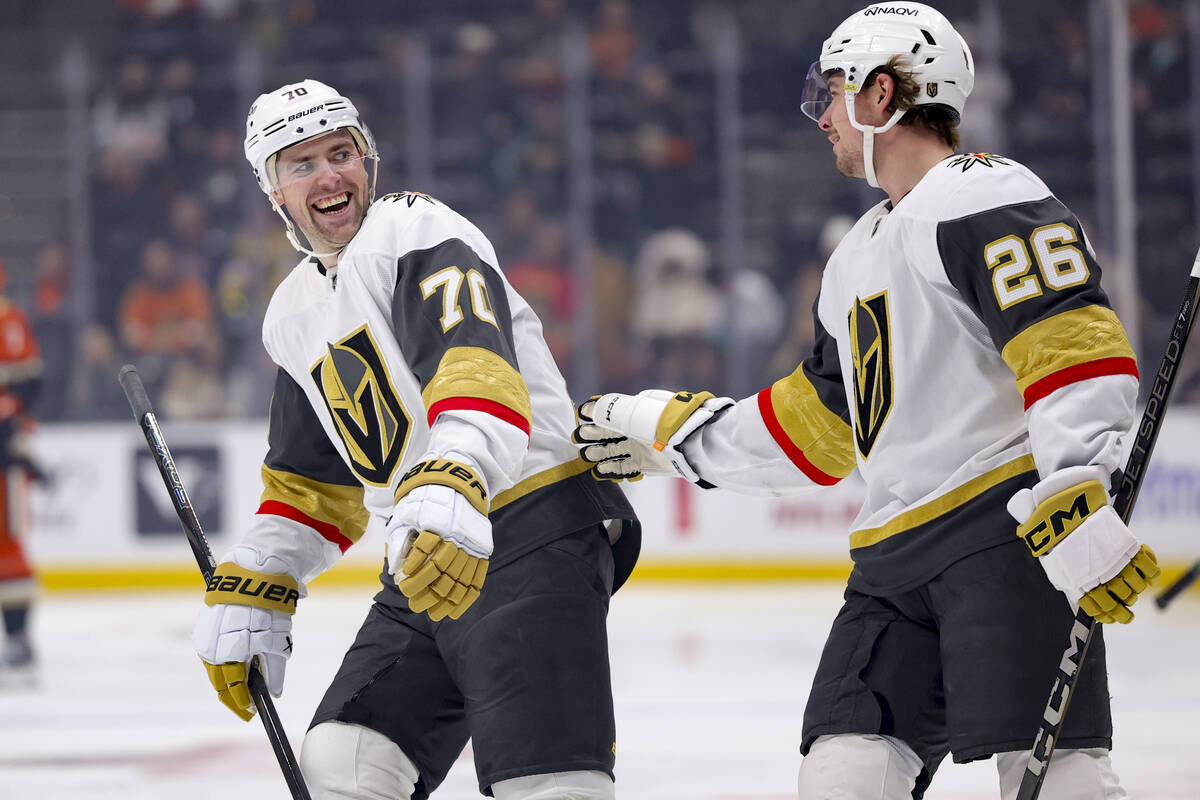 Vegas Golden Knights right wing Alexander Holtz, right, celebrates his goal with left wing Tann ...