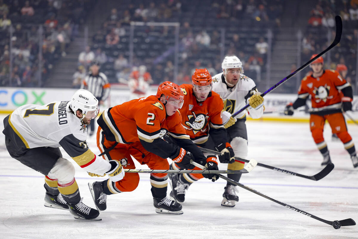 Anaheim Ducks defenseman Jackson LaCombe (2) vies for the puck with Vegas Golden Knights defens ...