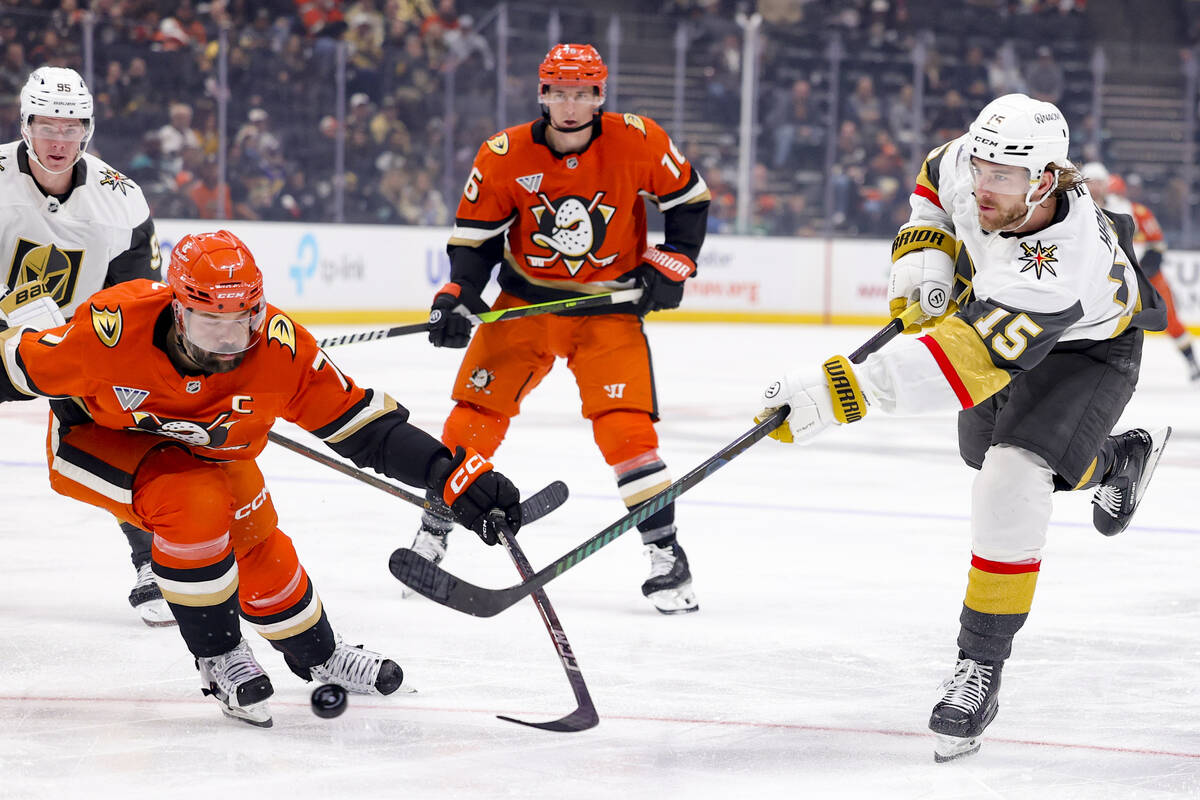 Vegas Golden Knights defenseman Noah Hanifin, right, shoots against Anaheim Ducks defenseman Ra ...