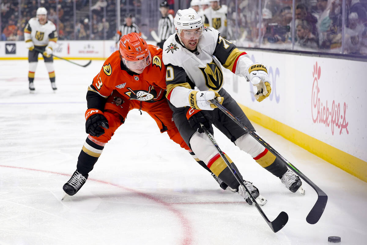 Vegas Golden Knights left wing Tanner Pearson, right, and Anaheim Ducks defenseman Drew Helleso ...