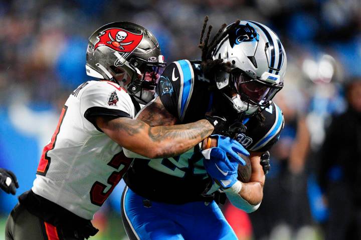 Carolina Panthers running back Jonathon Brooks is tackled by Tampa Bay Buccaneers safety Antoin ...