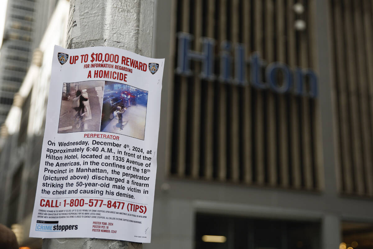 A reward poster hangs on a light pole outside the Hilton Hotel in midtown Manhattan where Brian ...