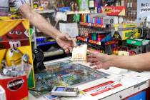 A person buys lottery tickets at Ernies Liquors in San Jose, California, on July 28, 2022. (Sha ...