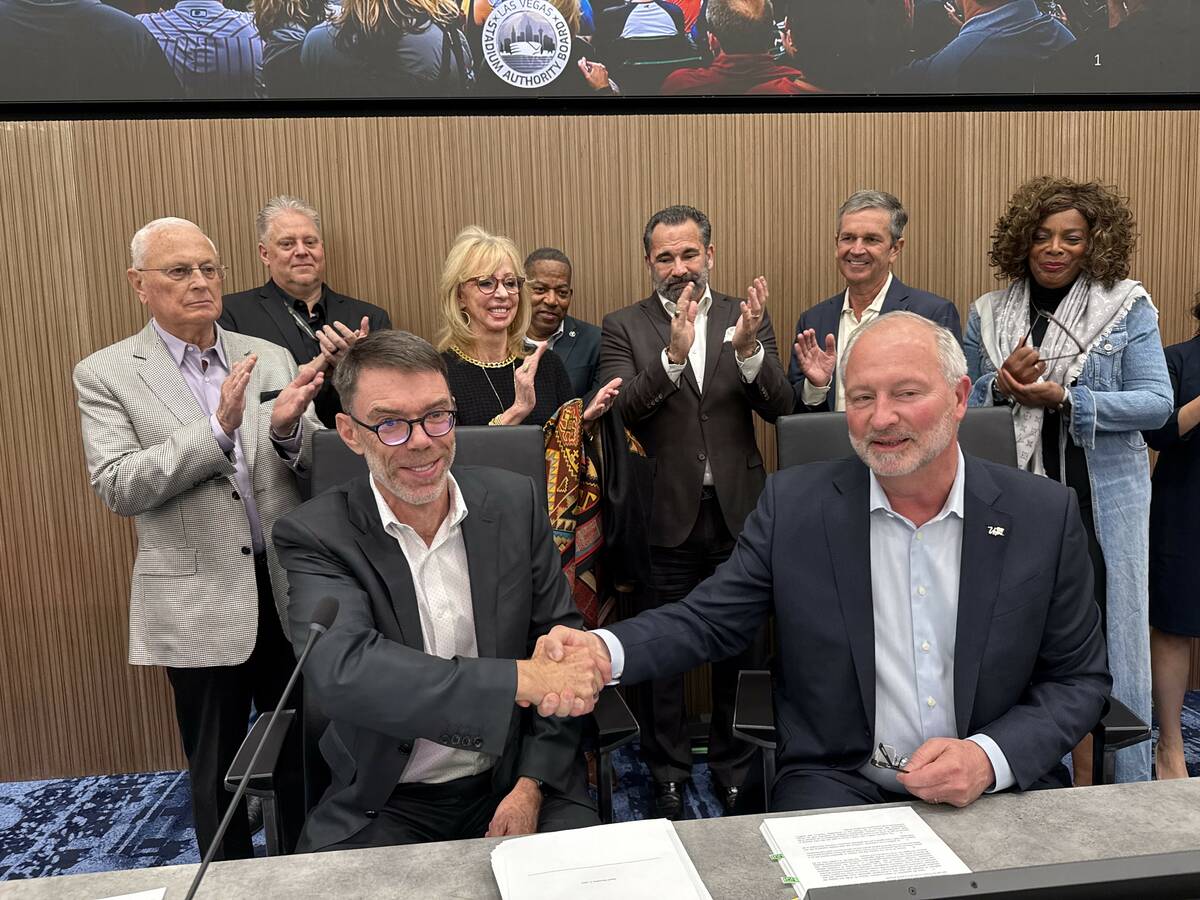 Athletics executive Sandy Dean (left) and Las Vegas Stadium Authority Chairman Steve Hill, shak ...