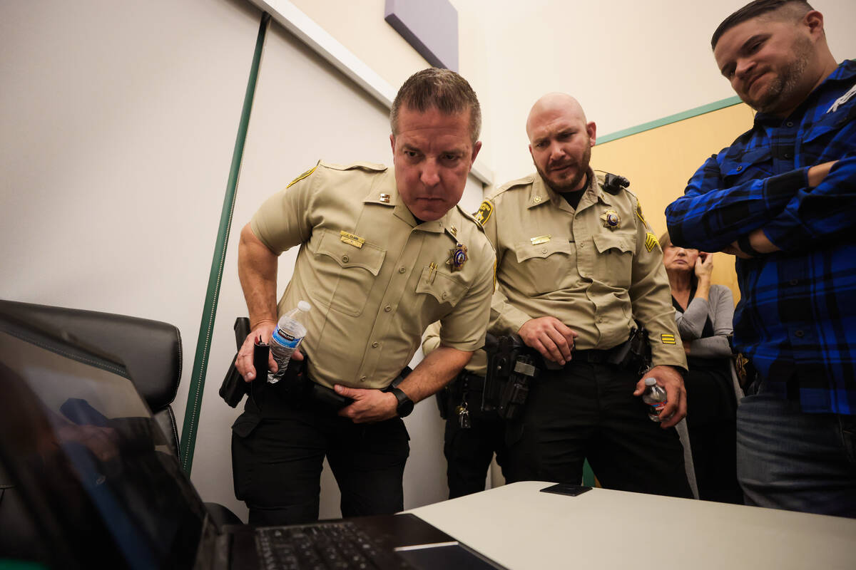 Metropolitan Police Department Captain Jeff Clark, left, and Sergeant Aaron Contreras, middle, ...