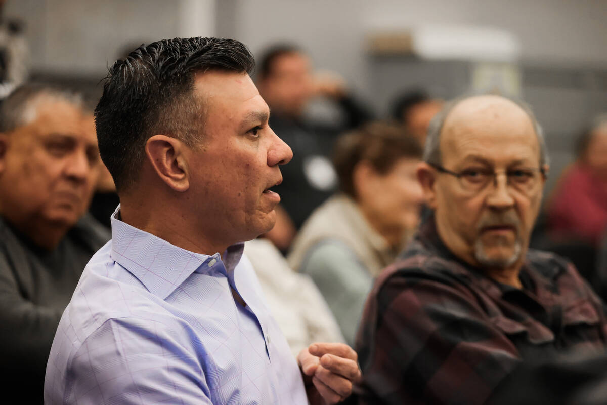 Steven Vaden, a local resident, asks questions from the audience during a community meeting on ...