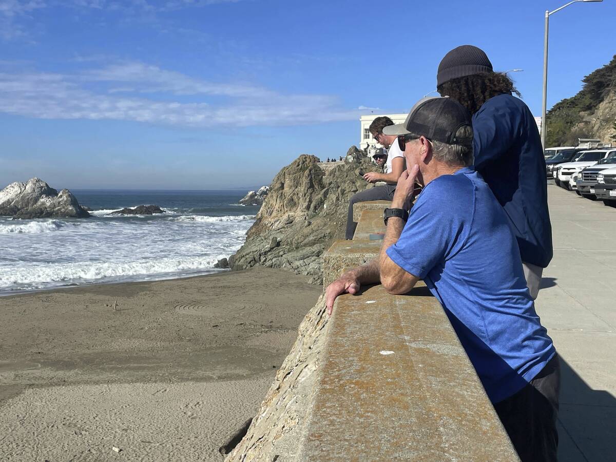 People watch the waves come in after an earthquake was felt widely across Northern California a ...