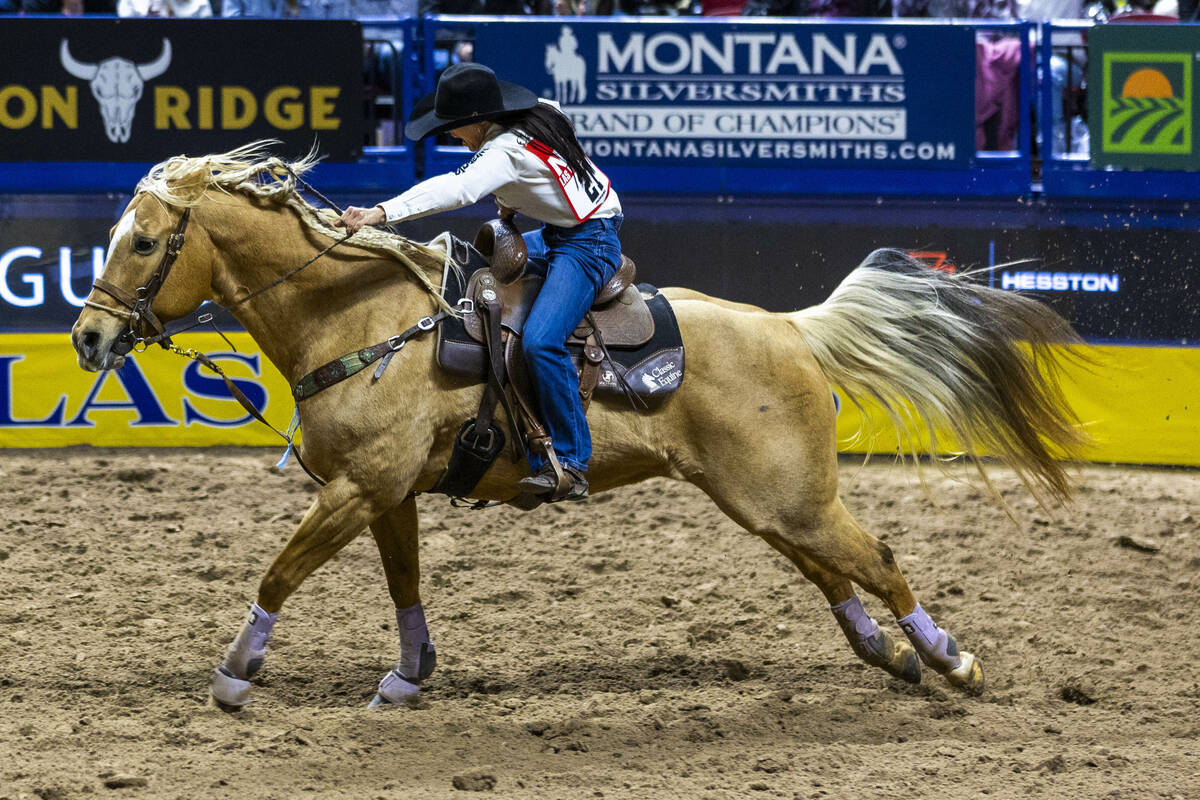 Barrel Racing competitor Hailey Kinsel heads to the finish on the way to a winning time during ...