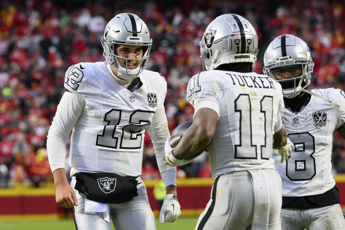 Las Vegas Raiders quarterback Aidan O'Connell (12) congratulates Raiders wide receiver Tre Tuck ...