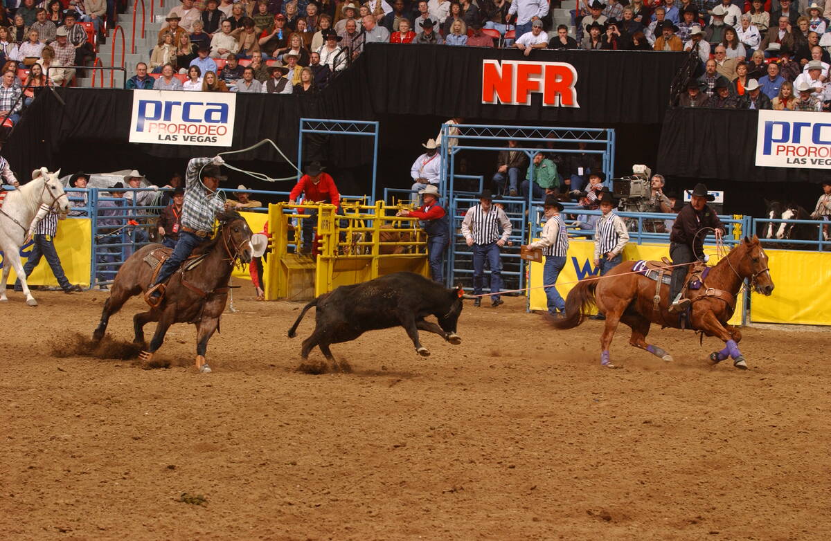 Team roping header Speed Williams, right, and heeler Rich Skelton, left, loop a steer at the 20 ...