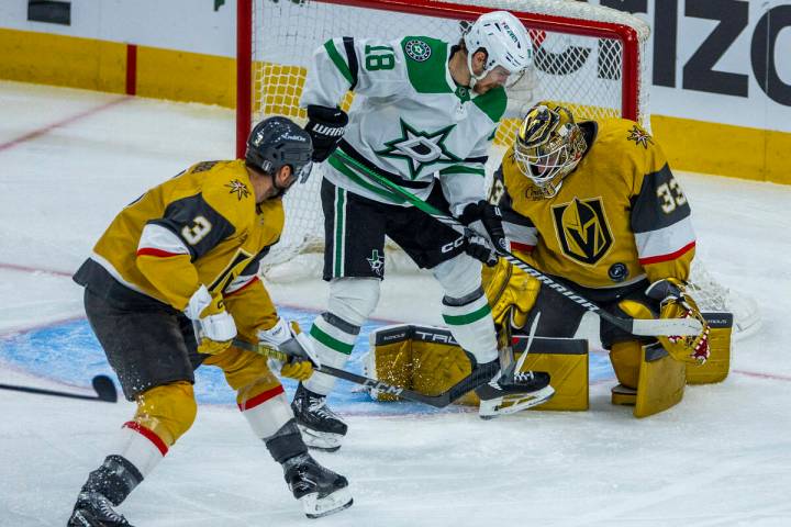 Golden Knights goaltender Adin Hill (33) deflects a shot by Dallas Stars center Sam Steel (18) ...