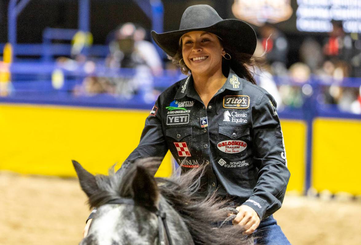 Hailey Kinsel takes a victory lap after winning the barrel racing event during opening night of ...