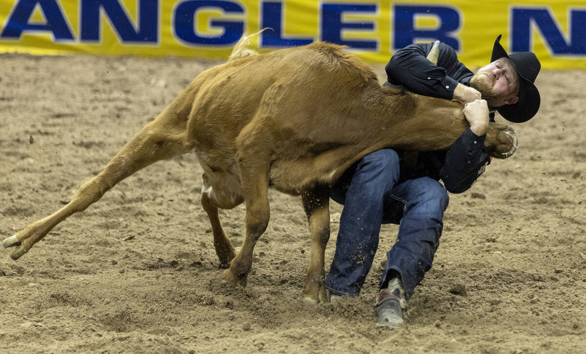 Will Lummus competes in the steer wrestling event during opening night of the National Finals R ...