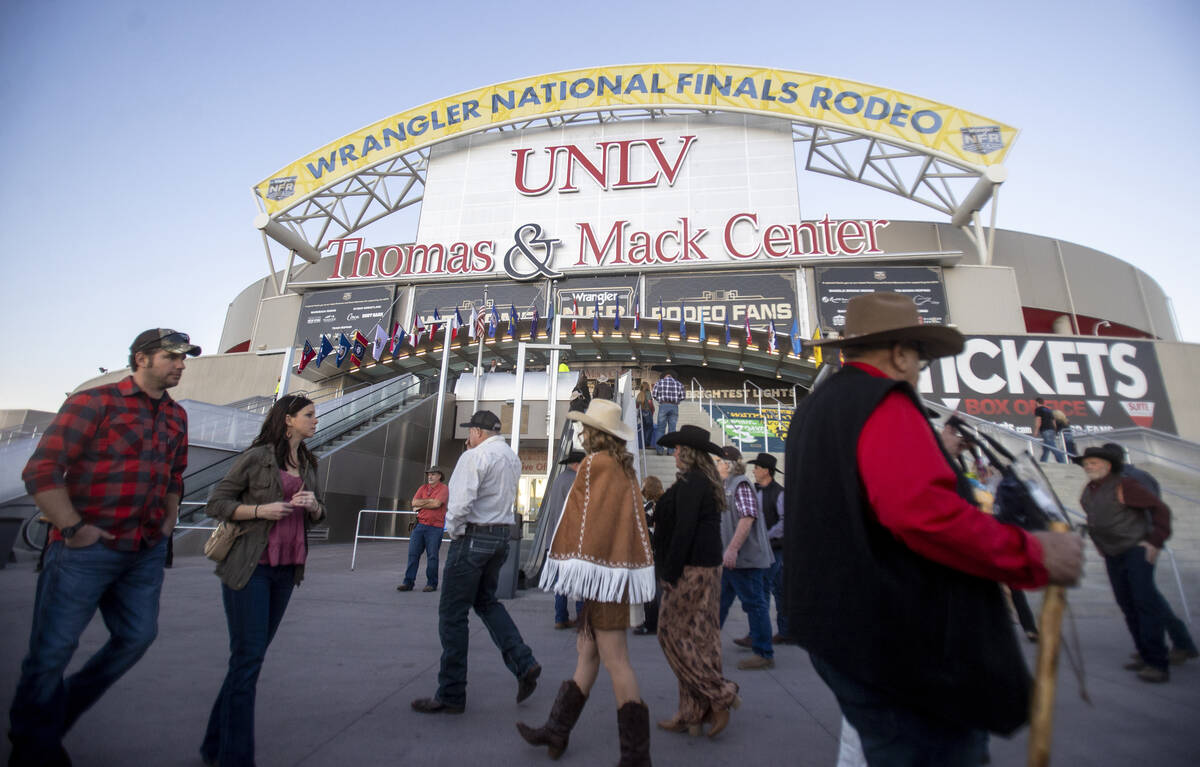 Attendees walk around before opening night of the National Finals Rodeo outside the Thomas &amp ...