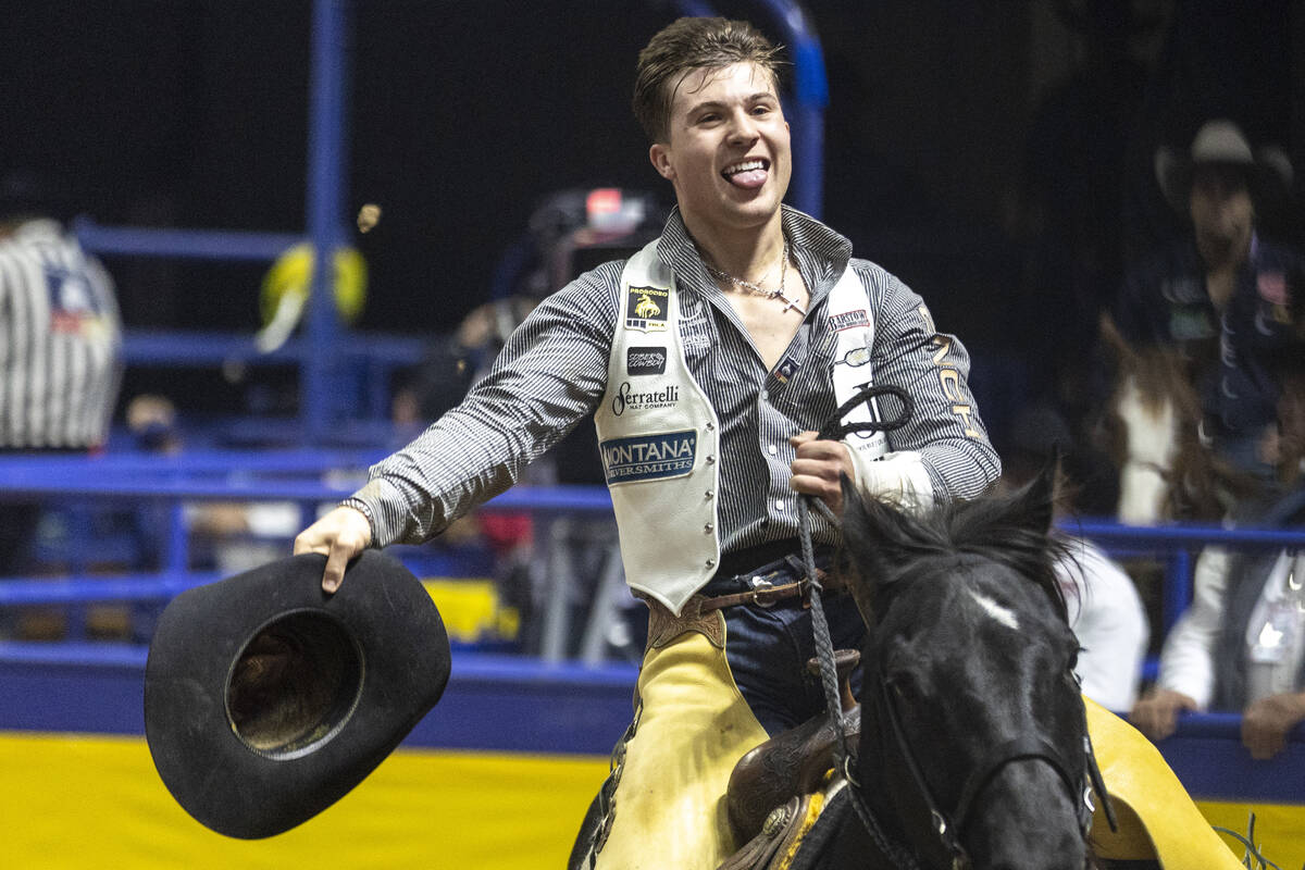 Weston Timberman takes a victory lap after winning the bareback riding event during opening nig ...