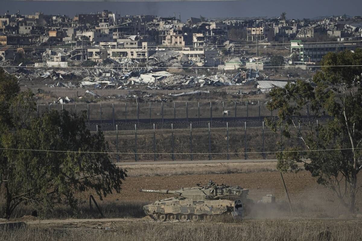 An Israeli armored vehicle transits around the Israel-Gaza border, as seen from southern Israel ...