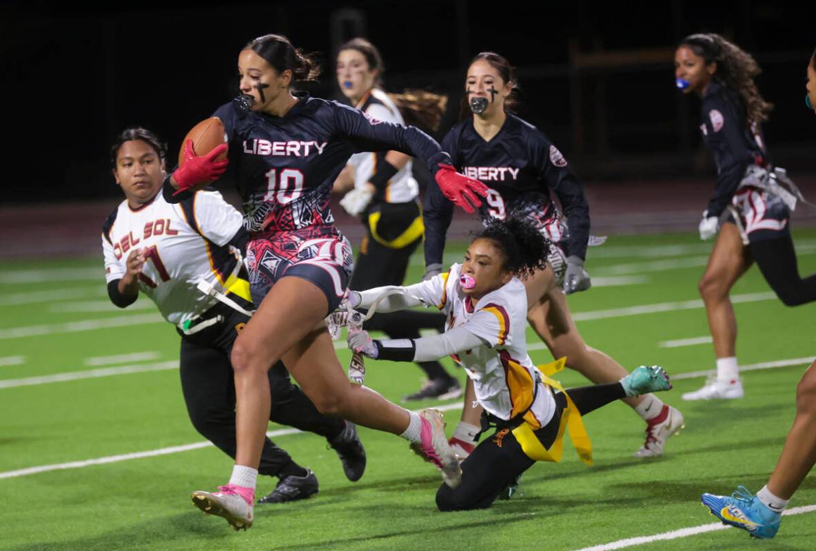 Liberty's safety Nai’a Pomaikai (10) runs the ball after an interception against Del Sol ...