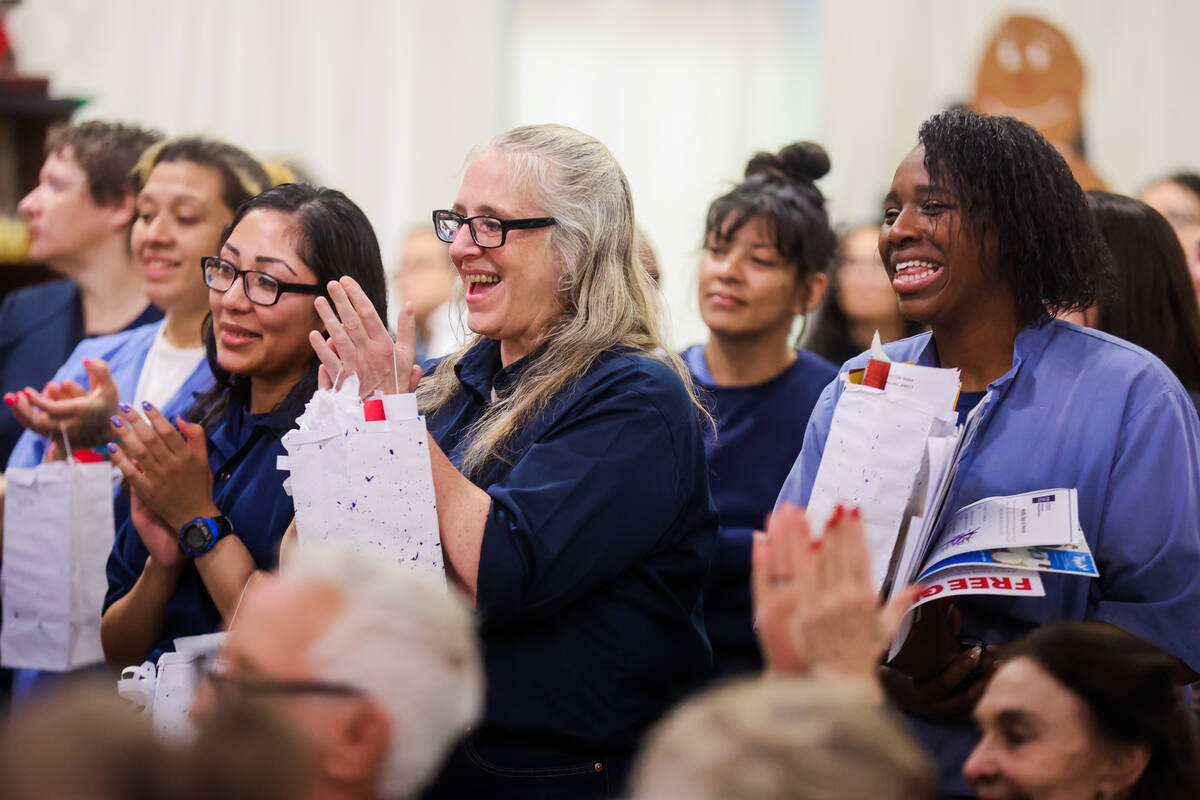 Inmates clap and cheer during an event to highlight incarcerated women who completed the touris ...