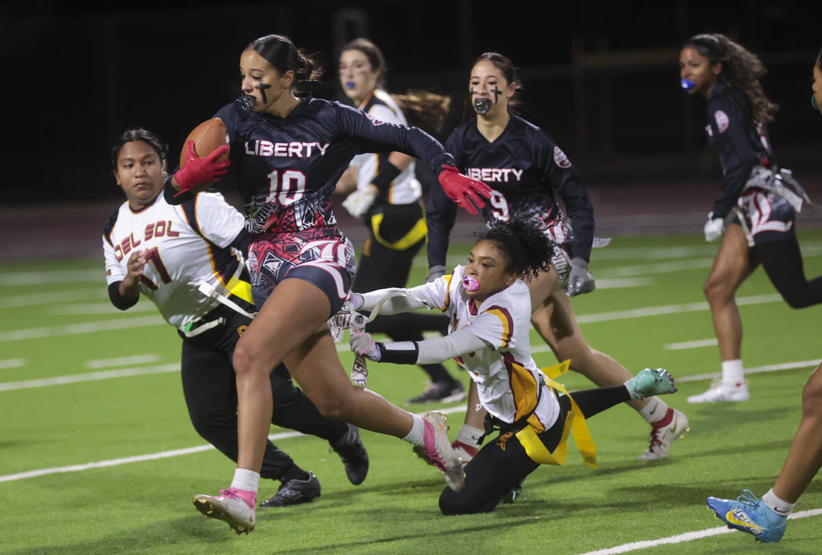 Liberty's safety Nai’a Pomaikai (10) runs the ball after an interception against Del Sol ...