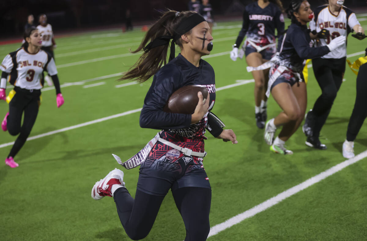 Liberty's Kaylie Phillips (14) runs the ball against Del Sol during a flag football game at Lib ...