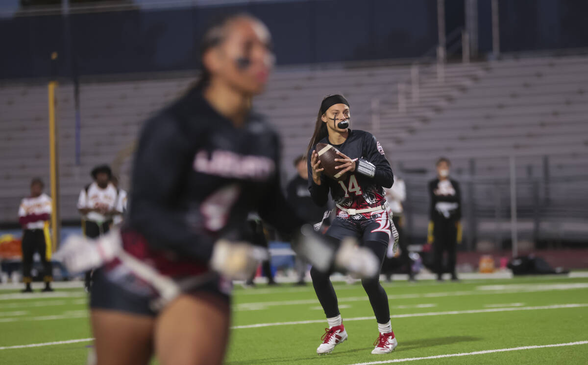 Liberty's Kaylie Phillips (14) looks to throw a pass during a flag football game against Del So ...