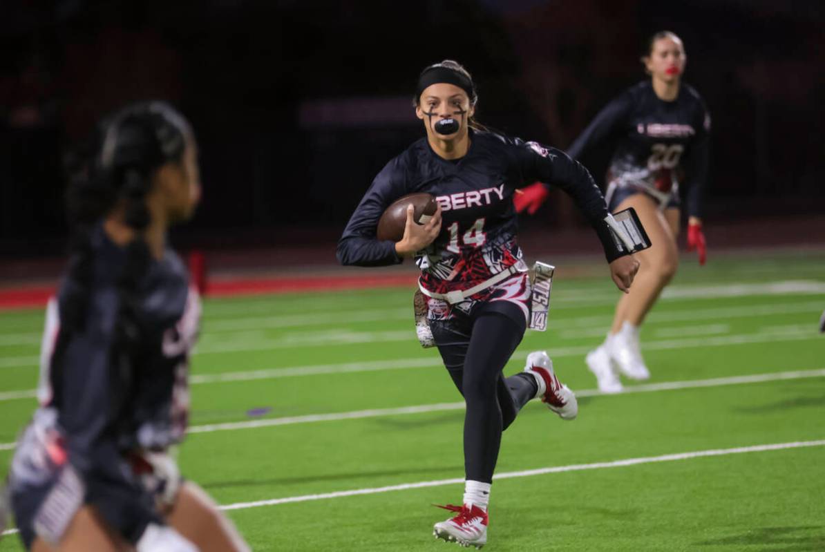 Liberty's Kaylie Phillips (14) runs the ball against Del Sol during a flag football game at Lib ...