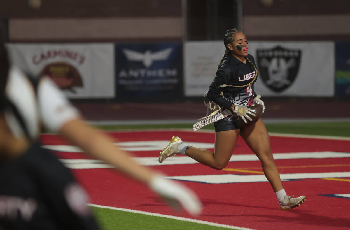 Liberty's Kilolo Westerlund (4) scores a touchdown against Del Sol during a flag football game ...