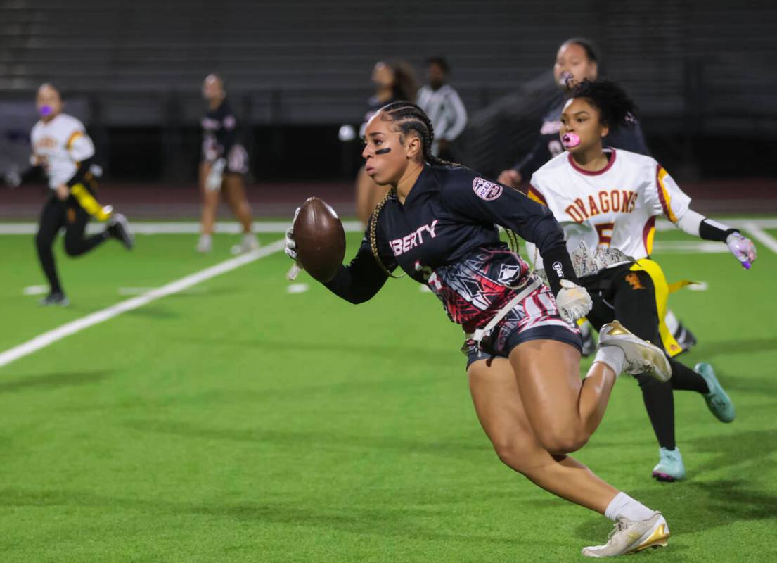 Liberty's Kilolo Westerlund (4) runs the ball against Del Sol during a flag football game at Li ...