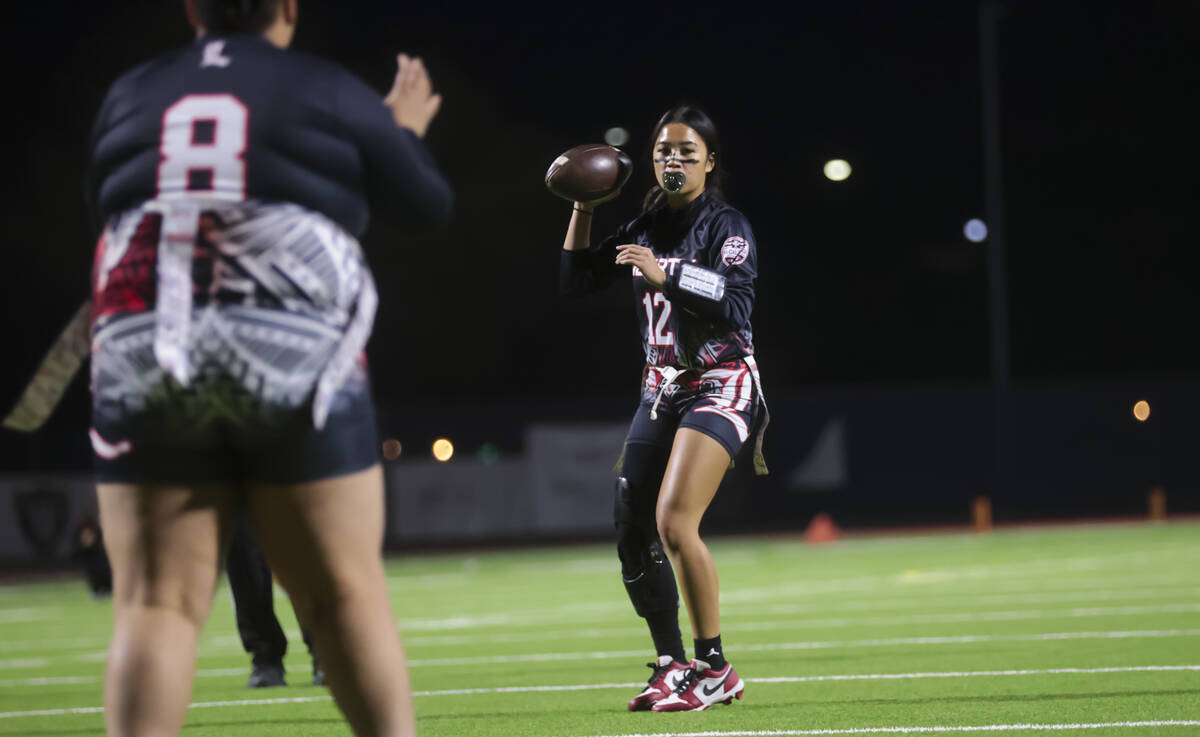 Liberty's Jianna Reyes (12) looks to throw a pass during a flag football game against Del Sol a ...